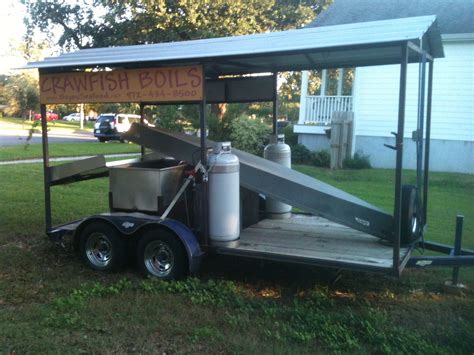 Metal covered roof with hanging lights and gated. . Crawfish boiling trailers for sale